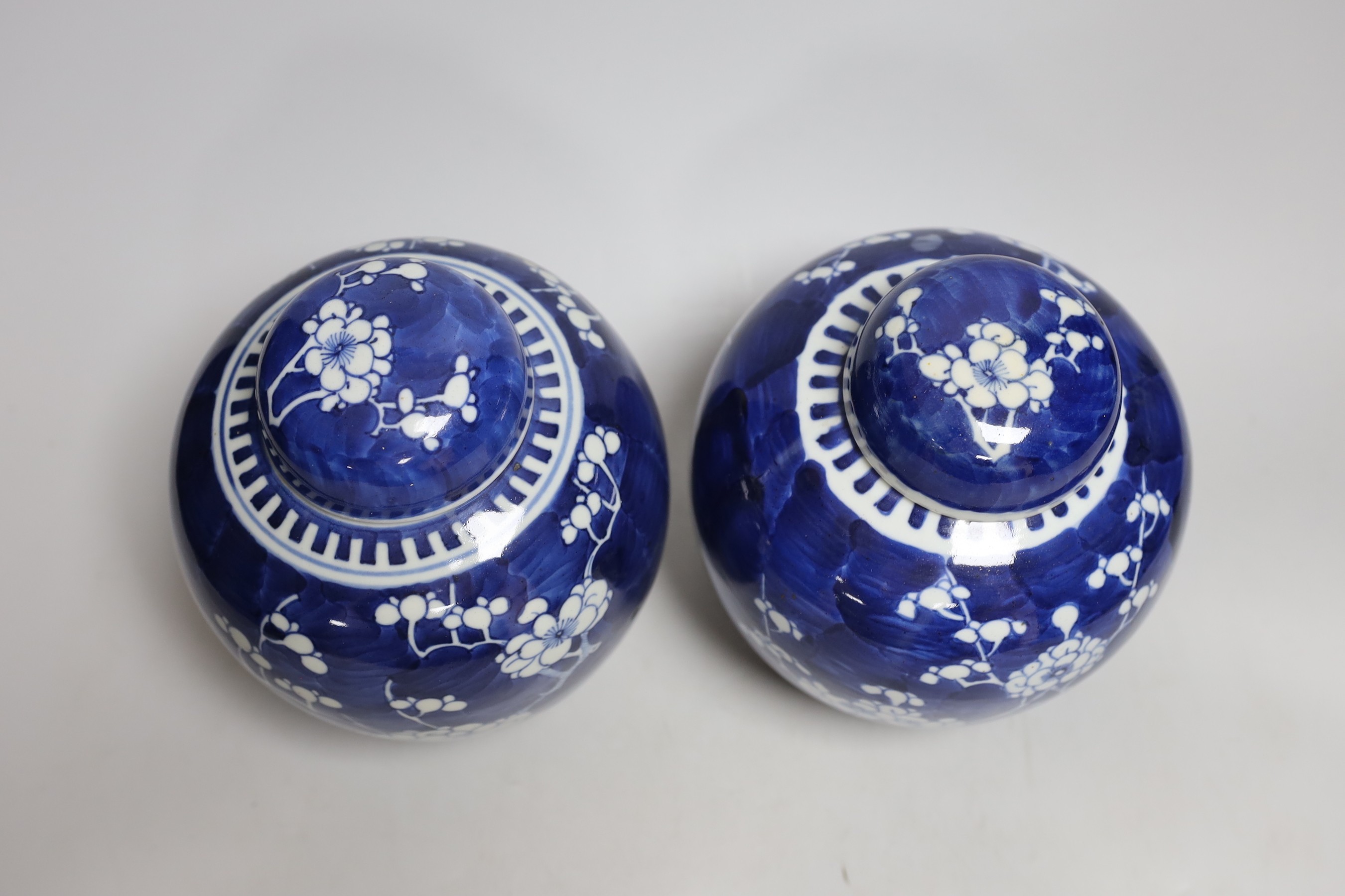 Two Chinese export porcelain Prunus blossom jars and covers, 20cms high